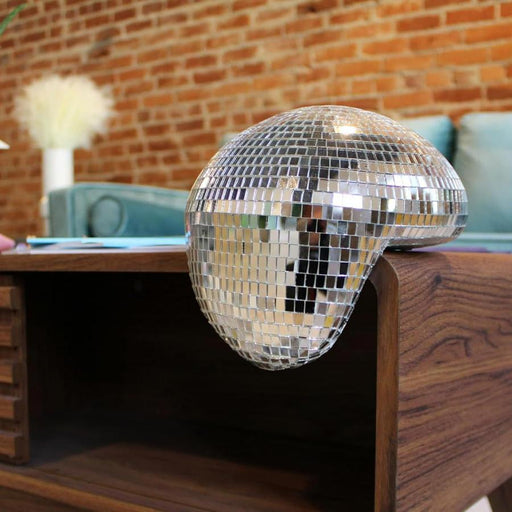 Melting Disco Ball that hangs over the shelf